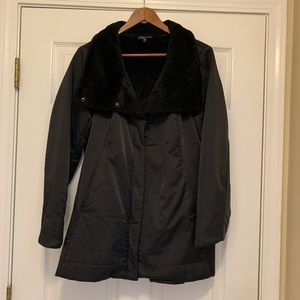 Eileen Fisher sophisticated black jacket. Sleek poly outer, faux fur collar.